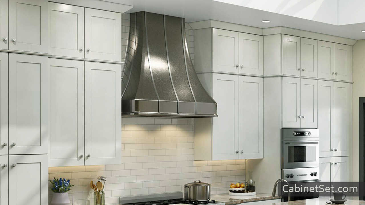 Camden Dove Shaker wall cabinets with a range hood.
