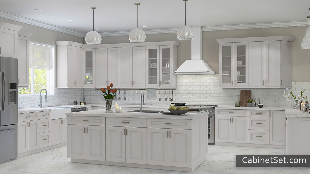 Salem Dove Shaker kitchen angle view with an island, a range hood cover, and a pantry cabinet.